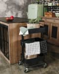 Cozy loft kitchen with dinning table, chairs and metal storage racks on wheels - trolley.