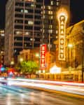 time exposure of traffic lights on congress avenue in downtown Austin infront of the Paramount and State theaters at night