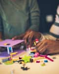 Worthy of creative hands. African American father and daughter playing with cubes. Focus on hands. Close up.