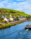 Moselle river by Wormeldange, Luxembourg country, with vineyard hills and a cargo barge ship