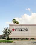 Vero Beach, Florida; USA;  June 23, 2019. Macy's  store logo is pictured on the outside of the store  a long with tall palm trees on a sunny day in Florida. Front view.