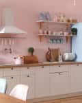 Stylish pink kitchen interior with dining table and chairs