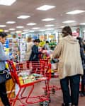 Reston, USA - March 13, 2020: Long lines in Trader Joe's store, people by shopping cart buying grocery products, paying at cashier registers in preparation for COVID-19 coronavirus quarantine