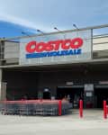 Mckinney, TX / USA - August 12, 2020: Costco Wholesale Entrance with shopping carts and customers in a sunny day