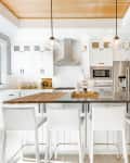 Modern farmhouse kitchen in white and natural wood counter