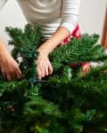 Unrecognizable woman assembling christmas tree