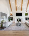 Modern farmhouse style living and family room with large windows cabinets in blues and greens