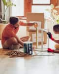 Couple painting wooden table by recycle, donate and thrift furniture for a new home improvement project in new apartment.