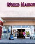 Charlottesville, USA - May 8, 2021: World Market store in Albemarle county, Virginia with sign at entrance and people for now hiring apply now during the jobs pandemic