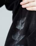 A woman's hand is showing white marks on deodorant stains in black clothes. Spoiled clothes. daily life stain concept.