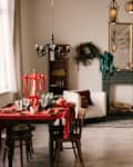 Beautiful New Year decor, the Christmas tree is decorated with red bows in the stylish interior of the living room
