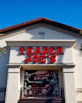 Sunnyvale, CA US - March 22, 2025: Trader Joe's logo sing on the store facade in Silicon Valley, blue sky, sunny . Trader Joe's is an American grocery store chain headquartered in Monrovia, California