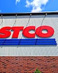 Raleigh, North Carolina - May 2 2025: Costco Wholesale Gold Star Membership Card Held In Hand in Front of Storefront Location