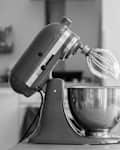 Stand mixer next to eggs and flour.
