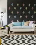 Spacious living room with a big sofa and a blackboard wall