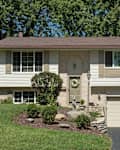 White, Split-level House With Lower Garage