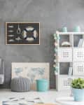 Grey home interior with nautical wall decor, sofa, carpet and white storage unit