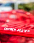 Red shopping carts with Trader Joes store sign on handle