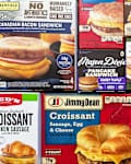 Assorted breakfast sandwich boxes featuring croissants, biscuits, and pancakes with various fillings like sausage, egg, and cheese.