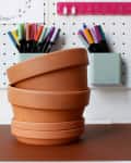 Before: stack of plain terracotta pots and saucers