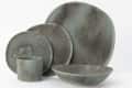 Stoneware dinner set with a rustic finish, including plates, bowl, and cup in earthy tones.