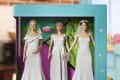 Three dolls in wedding dresses with bouquets in a colorful box labeled "Monica & Rachel & Phoebe Wedding Dresses Set."