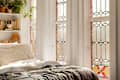 Stained glass window in stylish bedroom.