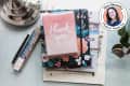 thank you notes/cards on top of a stack of notebooks and books on a desk. decorative pencils, a lamp, and a plant also in photo