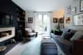 Modern living room with gray sofa, blue rug, wall art, and glass doors leading to a garden.