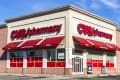 CVS Pharmacy storefront with red awnings, large logo, and drive-thru pharmacy signage.