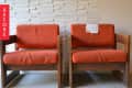 Two vintage wooden chairs with orange cushions in front of a textured white wall, labeled "Before."