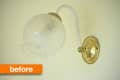 Brass wall sconce with frosted glass globe and white arm, labeled "before."
