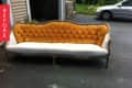 Vintage sofa with orange tufted back and white seat on driveway, labeled "Before."