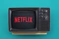 Retro TV displaying the Netflix logo on a teal background.
