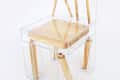 Wooden chair with clear acrylic frame, featuring wooden seat, backrest, and legs encased in transparent sections.