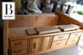 Wooden dresser with multiple drawers in a garage, labeled "Before."