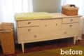 White dresser with multiple drawers, wicker baskets, and a green changing pad on top.