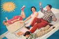 Family sliding down a giant washboard with a large soap bar, under a smiling sun on a blue background.