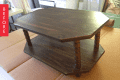 Dark wooden octagonal coffee table with two tiers and spindle legs, labeled "Before."