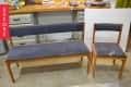 Wooden bench and chair with dark cushions in a workshop, labeled "Before."
