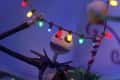 Skeleton character holding colorful Christmas lights in a festive setting.