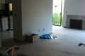 Unfurnished living room with carpet, fireplace, sliding glass door, and unpacked boxes.