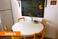 Small dining area with a round white table, four wooden chairs, and a chalkboard wall with notes and drawings.