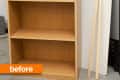 Wooden bookshelf with three shelves, white panel, and wooden strips labeled "before."