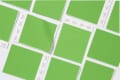 Multiple Pantone swatches in vibrant green, arranged in a grid pattern.