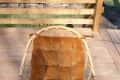 Rattan chair with a tufted brown cushion on a wooden deck, labeled "before."