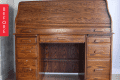 Roll-top wooden desk with multiple drawers and a central open shelf, labeled "Before" on the left side.