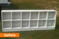 White wooden cubby shelf with ten compartments on grass, labeled "before."