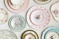 an eclectic assortment of floral china plates