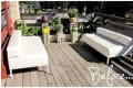 Two white sofas on a wooden deck with potted plants and "Before" text.